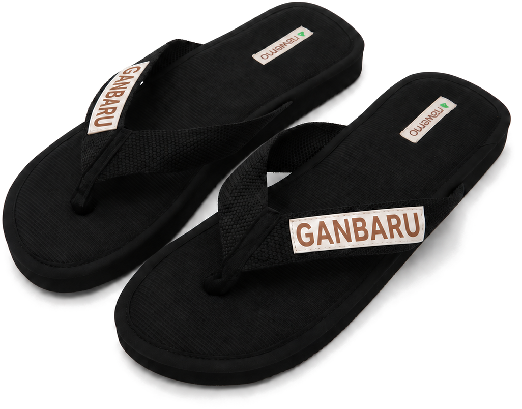 Black cinnamon slippers with Tho Cam embroidery and 'Ganbaru' lettering.